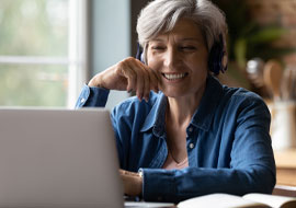 woman looking at a laptop, smiling