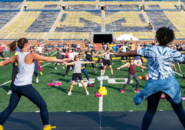 large group of people doing zumba in the Big House