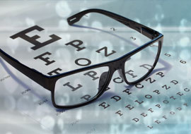 eye glasses on top of an eye exam chart