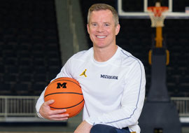 coach May holding a basketball