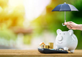 a piggy bank with someone holding a small umbrella over it