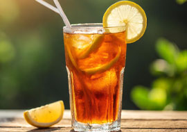 a glass of ice tea with a lemon garnish