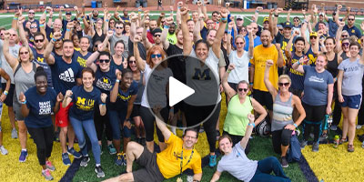 group of people on the field of Michigan Stadium