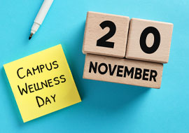 wood blocks with November 20 on them and a sticky note that says Campus Wellness Day
