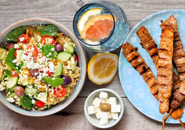 A salad and a plate of cooked chicken