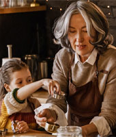 photo of woman with a little kid baking