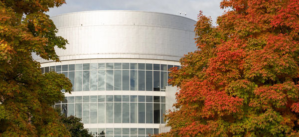 Dearborn campus with a large tree with the leave changing color for the fall